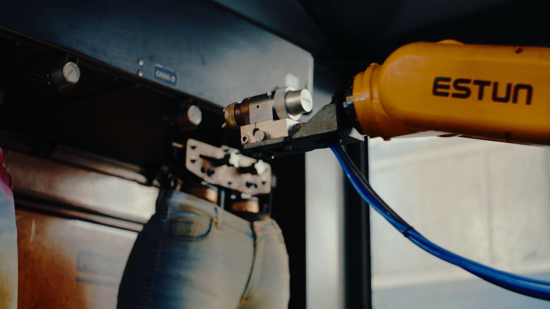 Robot applying permanganate to denim